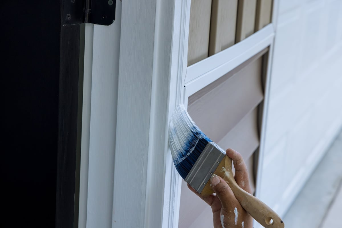 Paintbrush used by contractor painter to paint door trims