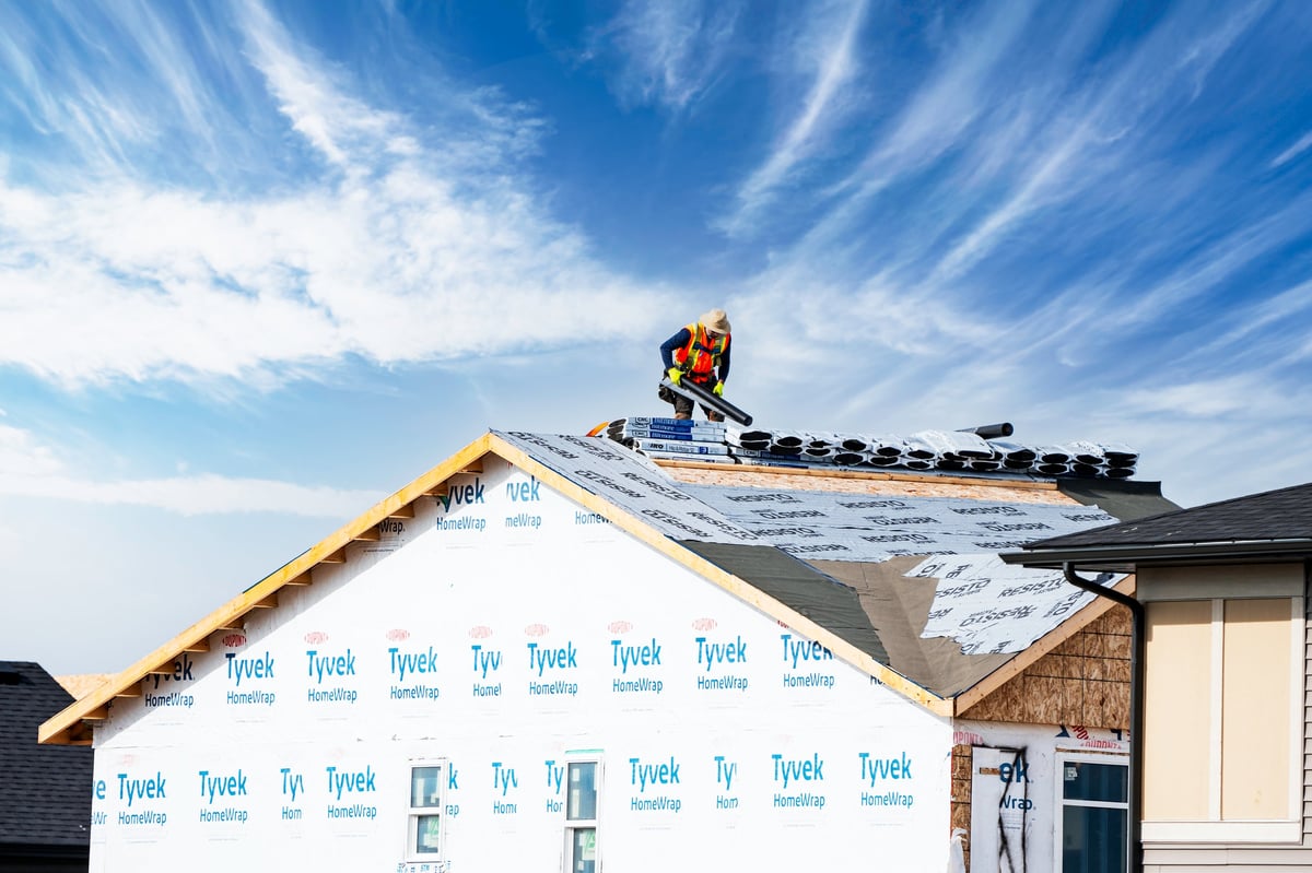 Roofer at work on new home under construction