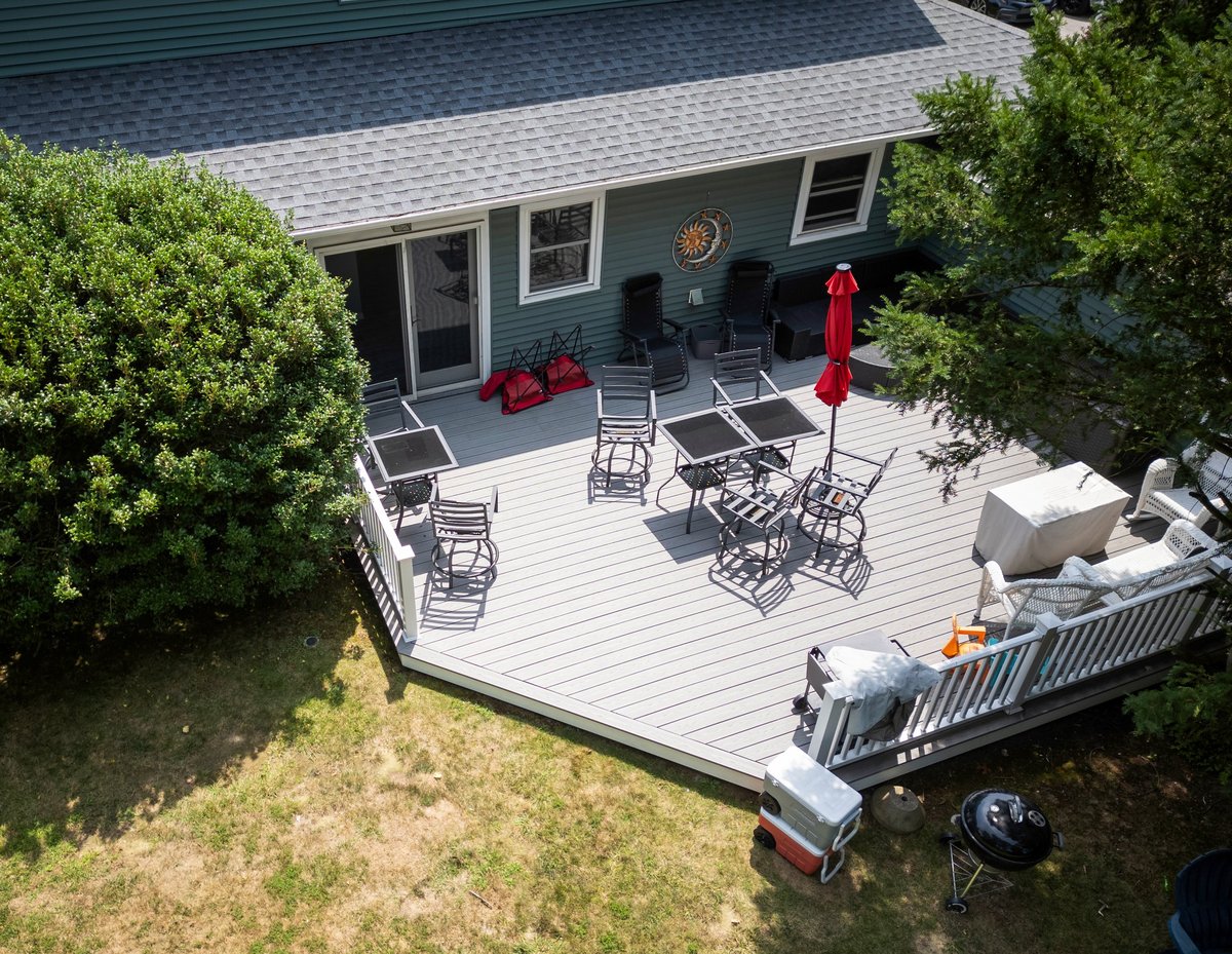 Drone view of deck on back of house with furniture for relaxation
