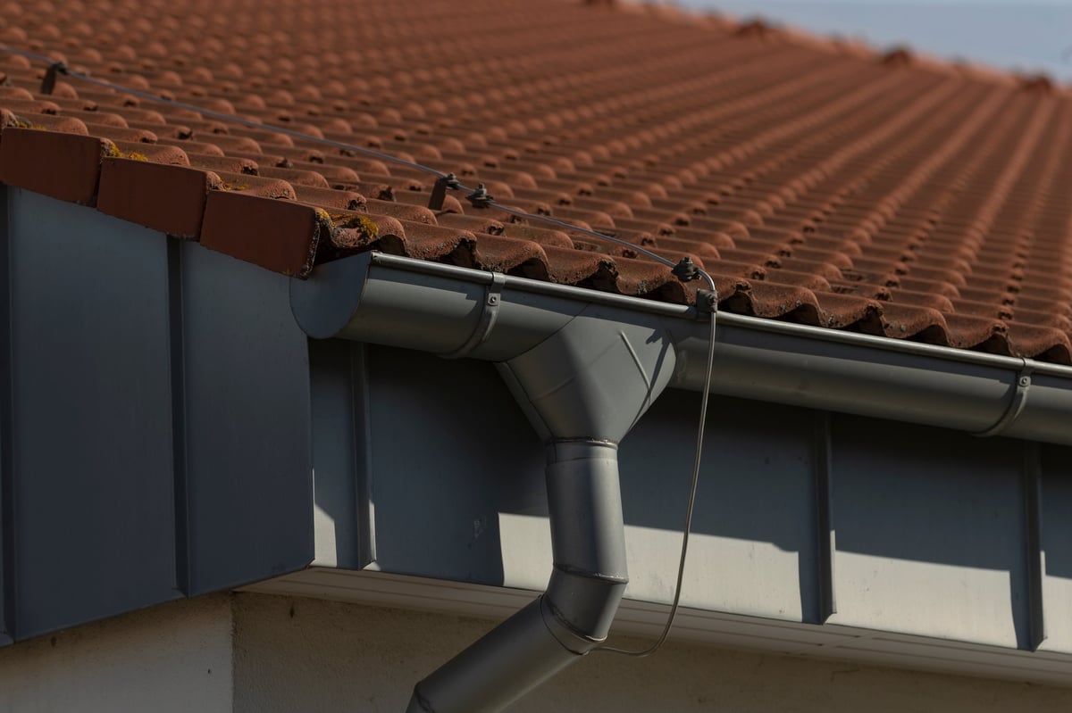 Closeup view of rain gutter installed on roof of residential house