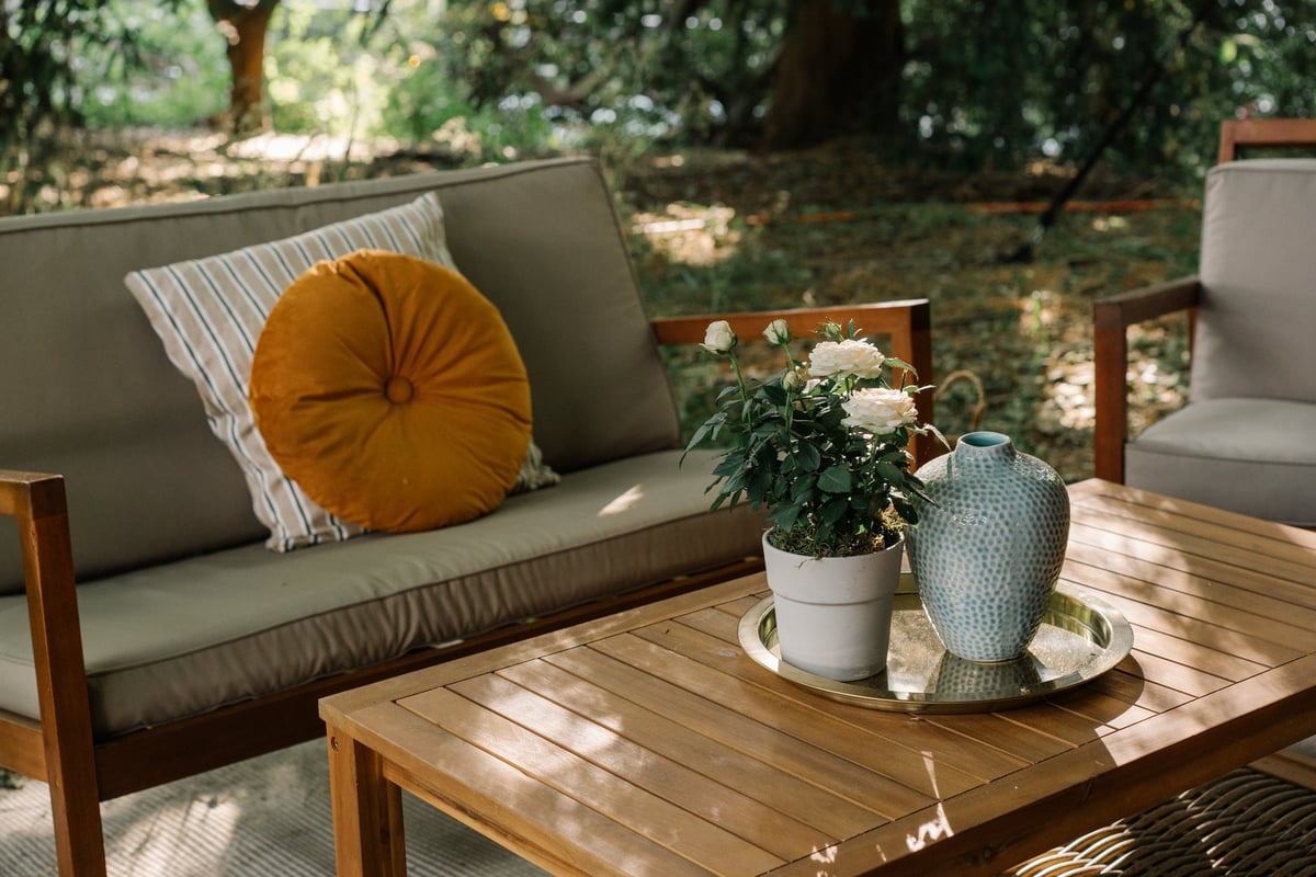 Modern table chairs and sofa in garden summer relaxing vibe