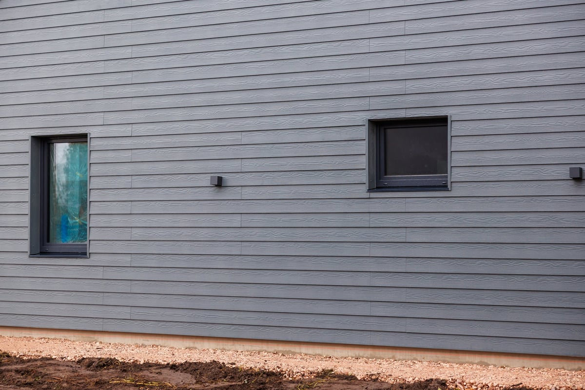 Grey horizontal lap siding with subtle woodgrain and wall sconces
