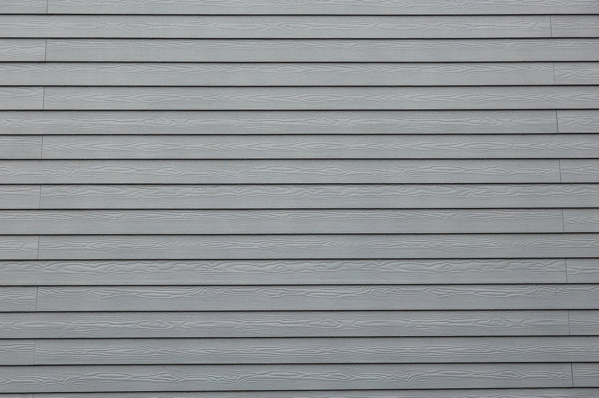 Uniform horizontal cladding panels with faux woodgrain embossing